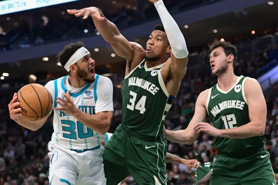 Feb 27, 2024; Milwaukee, Wisconsin, USA; Charlotte Hornets guard Seth Curry (30) looks for a shot against Milwaukee Bucks forward Giannis Antetokounmpo (34) and forward Danilo Gallinari (12) in the second quarter at Fiserv Forum. Mandatory Credit: Benny Sieu-USA TODAY Sports