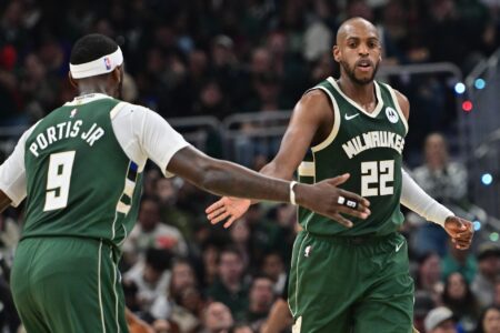 Apr 21, 2024; Milwaukee, Wisconsin, USA;Milwaukee Bucks forward Khris Middleton (22) is greeted by forward Bobby Portis (9) after scoring a basket in the second quarter against the Indiana Pacers during game one of the first round for the 2024 NBA playoffs at Fiserv Forum. Mandatory Credit: Benny Sieu-USA TODAY Sports