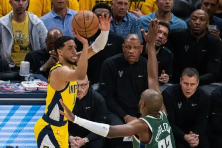 May 2, 2024; Indianapolis, Indiana, USA; Indiana Pacers guard Tyrese Haliburton (0) shoots the ball while Milwaukee Bucks forward Khris Middleton (22) defends during game six of the first round for the 2024 NBA playoffs at Gainbridge Fieldhouse. Mandatory Credit: Trevor Ruszkowski-USA TODAY Sports