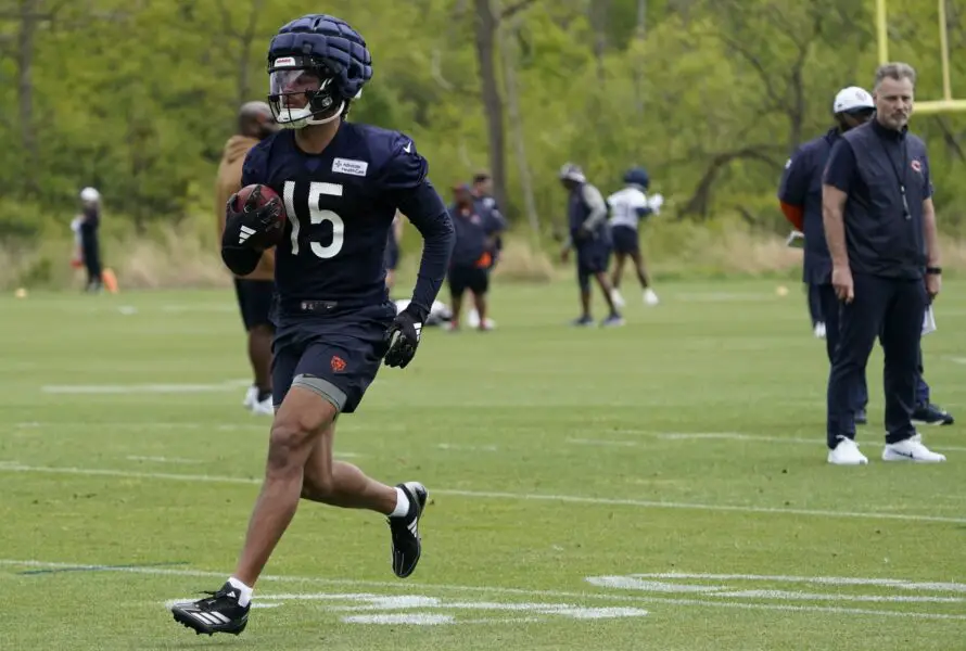 May 10, 2024; Lake Forest, IL, USA; Chicago Bears wide receiver Rome Odunze (15) runs drills as head coach Matt Eberflus looks on during Chicago Bears rookie minicamp at Halas Hall. Mandatory Credit: David Banks-USA TODAY Sports (Green Bay Packers)