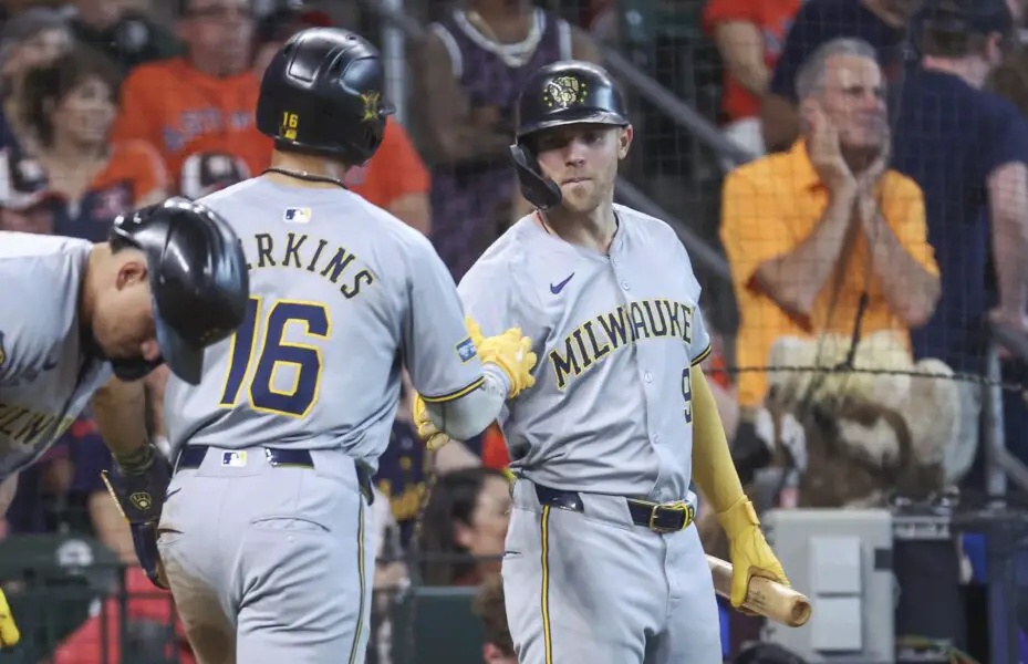 May 19, 2024; Houston, Texas, USA; Milwaukee Brewers first baseman Jake Bauers (9) congratulates center fielder Blake Perkins (16) after Perkins scores a run during the seventh inning against the Houston Astros at Minute Maid Park. Mandatory Credit: Troy Taormina-USA TODAY Sports