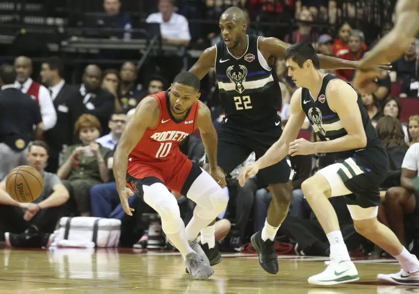 Oct 24, 2019; Houston, TX, USA; Houston Rockets guard Eric Gordon (10) and Milwaukee Bucks center Brook Lopez (11) and forward Ersan Ilyasova (7) go after a loose ball in the first quarter at Toyota Center. Mandatory Credit: Thomas B. Shea-USA TODAY Sports