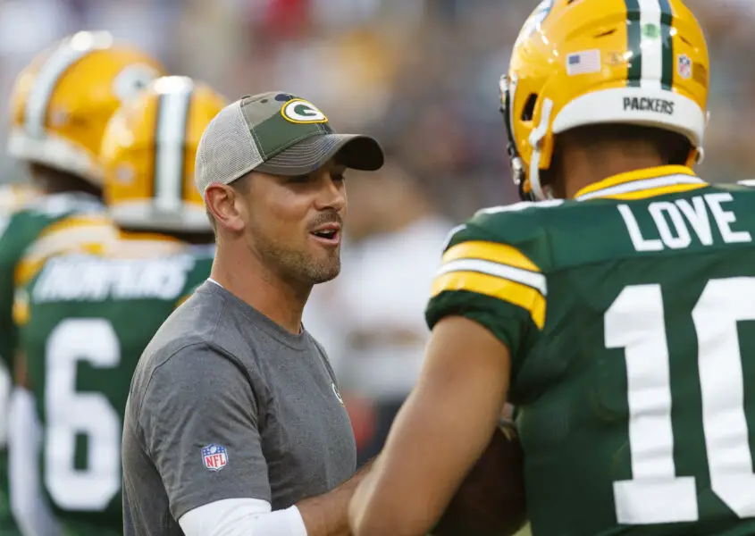 Aug 14, 2021; Green Bay, Wisconsin, USA; Green Bay Packers head coach Matt LaFleur talks with quarterback Jordan Love (10) during warmups prior to a game against the Houston Texans at Lambeau Field. Mandatory Credit: Jeff Hanisch-USA TODAY Sports