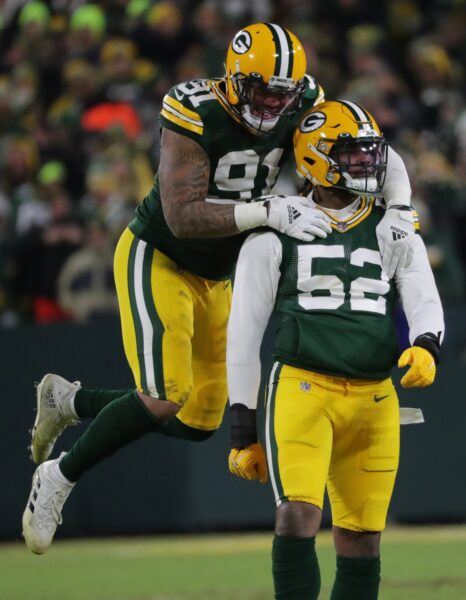 Green Bay Packers outside linebacker Preston Smith leaps on outside linebacker Rashan Gary (52) to celebrate Gary's sack of San Francisco 49ers quarterback Jimmy Garoppolo during the first quarter of the NFC divisional playoff round game Saturday, Jan. 22, 2022, at Lambeau Field in Green Bay, Wis.© Mark Hoffman / USA TODAY NETWORK