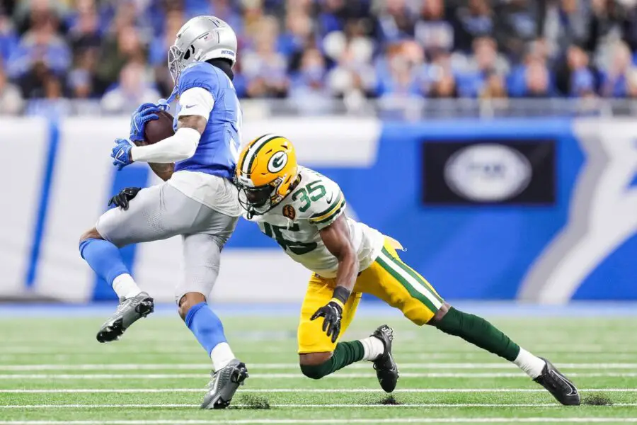 Detroit Lions receiver Jameson Williams makes a catch against Green Bay Packers cornerback Corey Ballentine during the first half at Ford Field in Detroit on Thursday, Nov. 23, 2023. © Junfu Han / USA TODAY NETWORK