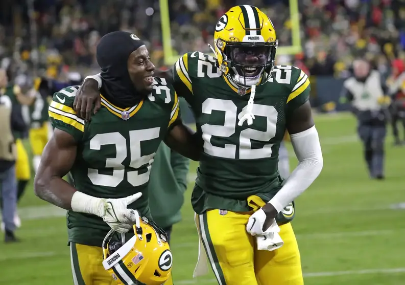 Dec 3, 2023; Green Bay, Wisconsin, USA; Green Bay Packers cornerback Corey Ballentine (35) and cornerback Robert Rochell (22) celebrate after defeating the Kansas City Chiefs at Lambeau Field. Mandatory Credit: Dan Powers-USA TODAY Sports