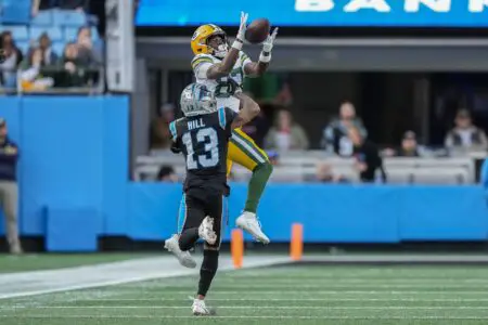 Dec 24, 2023; Charlotte, North Carolina, USA; Green Bay Packers wide receiver Romeo Doubs (87) goes up for a catch defended by Carolina Panthers cornerback Troy Hill (13) during the second half at Bank of America Stadium. Mandatory Credit: Jim Dedmon-USA TODAY Sports