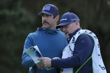 Feb 1, 2024; Pebble Beach, California, USA; New York Jets quarterback Aaron Rodgers (left) talks with his caddie on the 11th hole during the first round of the AT&T Pebble Beach Pro-Am golf tournament at Spyglass Hill Golf Course. Mandatory Credit: Michael Madrid-USA TODAY Sports