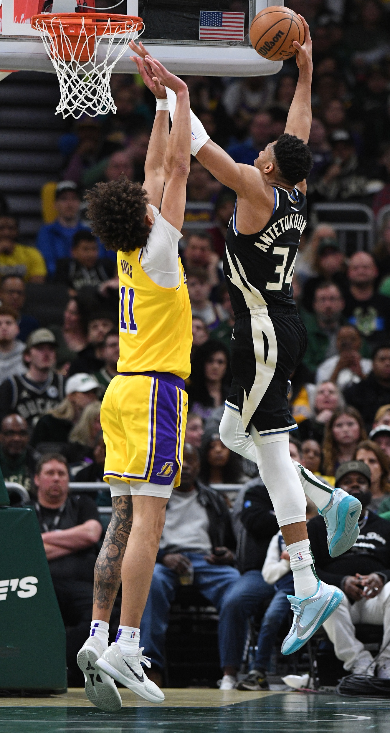 Mar 26, 2024; Milwaukee, Wisconsin, USA; Milwaukee Bucks forward Giannis Antetokounmpo (34) takes a shot against Los Angeles Lakers center Jaxson Hayes (11) during the second half at Fiserv Forum. Mandatory Credit: Michael McLoone-USA TODAY Sports