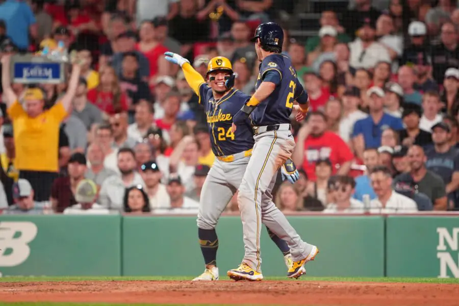 May 24, 2024; Boston, Massachusetts, USA; Milwaukee Brewers catcher William Contreras (24) and designated hitter Christian Yelich (22) react to scoring runs on shortstop Willy Adames (not pictured) RBI double against the Boston Red Sox during the fifth inning at Fenway Park. Mandatory Credit: Gregory Fisher-USA TODAY Sports