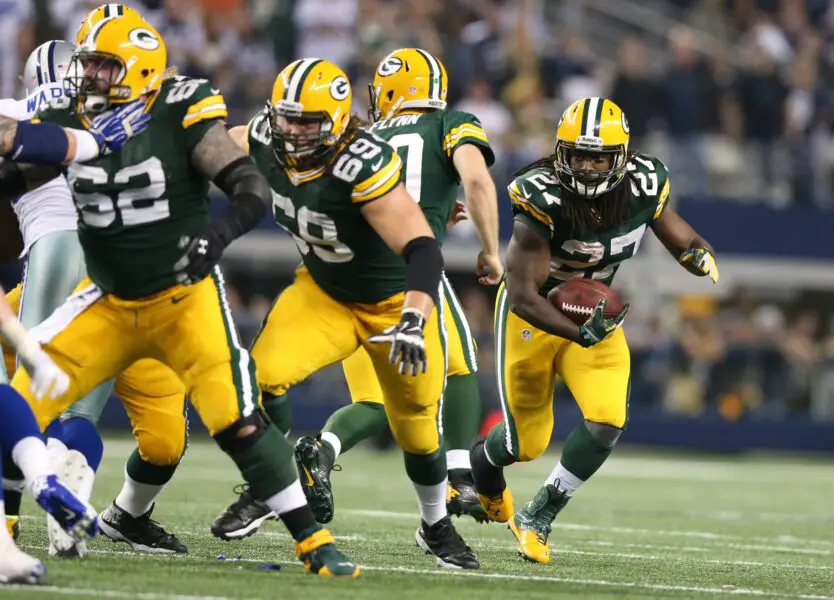 Dec 15, 2013; Arlington, TX, USA; Green Bay Packers running back Eddie Lacy (27) runs with the ball with lead blocking provided by tackle David Bakhtiari (69) and center Evan Dietrich-Smith (62) against the Dallas Cowboys at AT&T Stadium. Mandatory Credit: Matthew Emmons-USA TODAY Sports