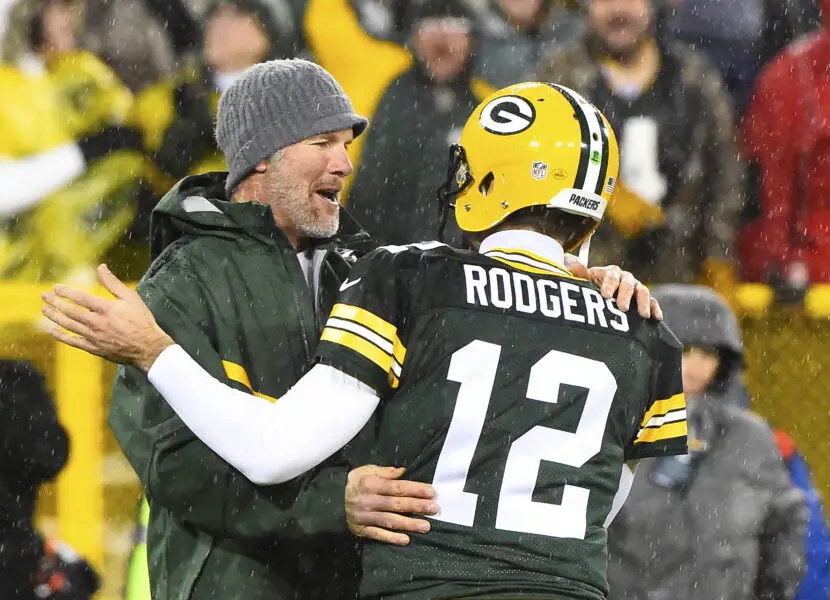 Nov 26, 2015; Green Bay, WI, USA; Green Bay Packers former quarterback Brett Favre hugs Green Bay Packers quarterback Aaron Rodgers (12) at half time for a NFL game against the Chicago Bears on Thanksgiving at Lambeau Field. Mandatory Credit: Mike DiNovo-USA TODAY Sports