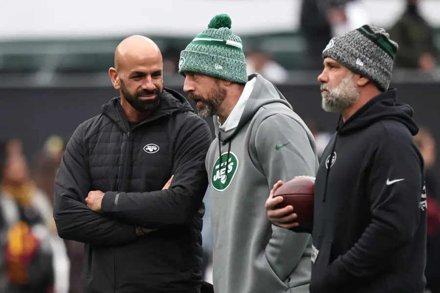 Dec 24, 2023; East Rutherford, New Jersey, USA; New York Jets head coach Robert Saleh (left) talks with quarterback Aaron Rodgers (center) before the game against the Washington Commanders at MetLife Stadium. Mandatory Credit: Vincent Carchietta-USA TODAY Sports