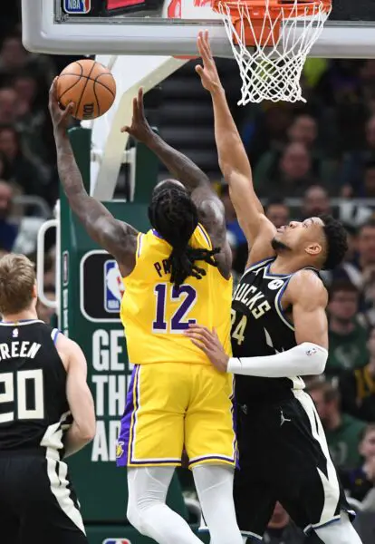 Mar 26, 2024; Milwaukee, Wisconsin, USA; Los Angeles Lakers forward Taurean Prince (12) puts up a shot against Milwaukee Bucks forward Giannis Antetokounmpo (34) in the first half at Fiserv Forum. Mandatory Credit: Michael McLoone-USA TODAY Sports
