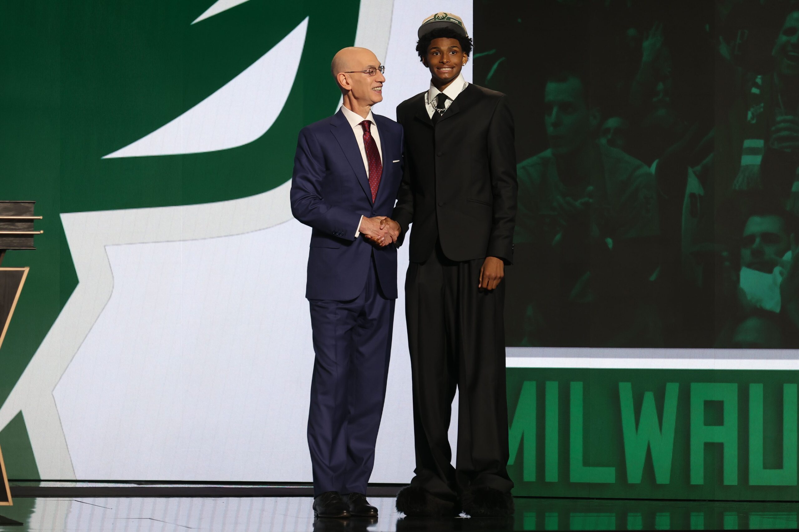 AJ Johnson poses for photos with NBA commissioner Adam Silver after being selected in the first round by the Milwaukee Bucs in the 2024 NBA Draft at Barclays Center. 