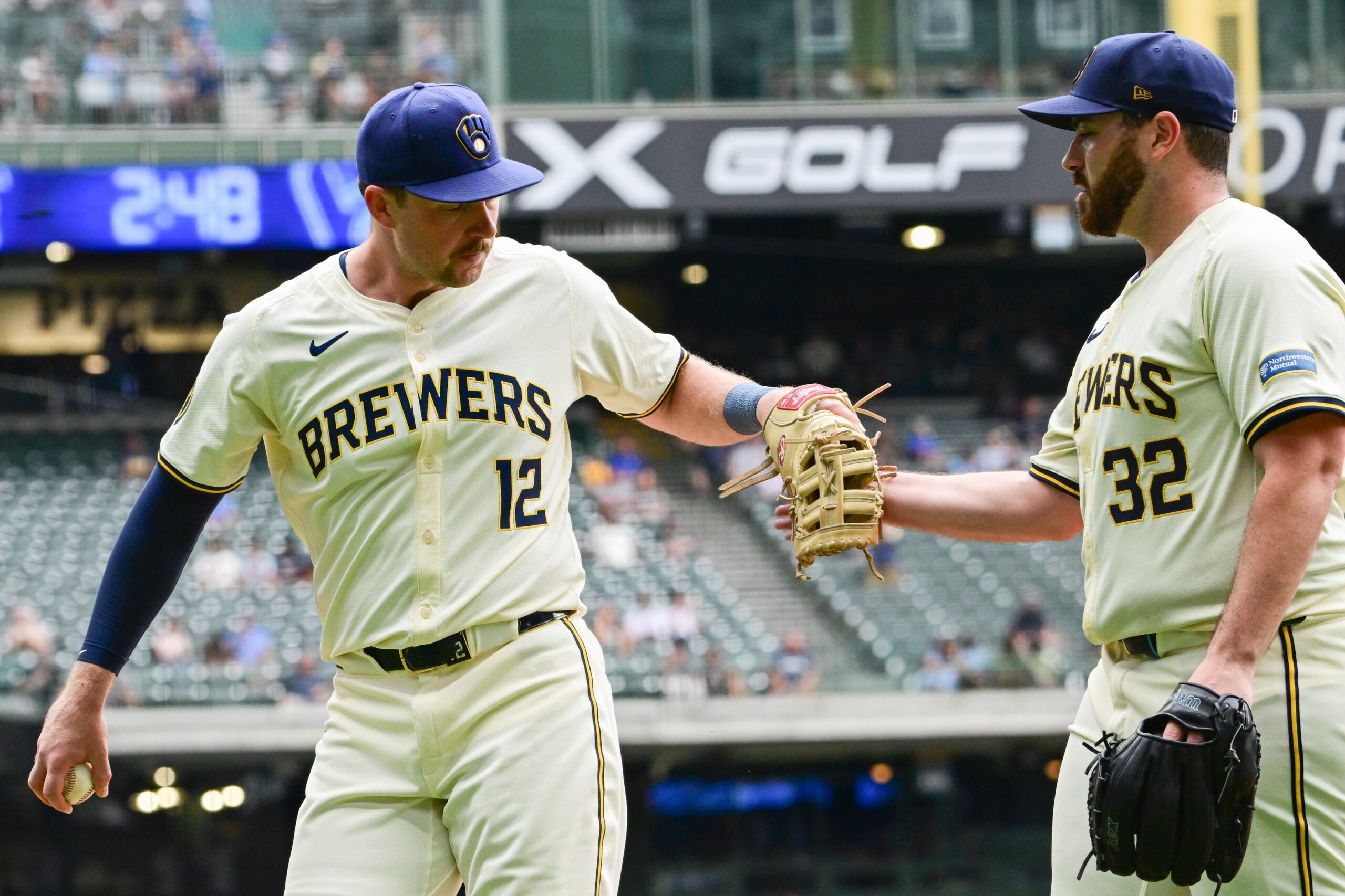 Milwaukee Brewers first baseman Rhys Hoskins (12) is greeted by starting pitcher Aaron Civale