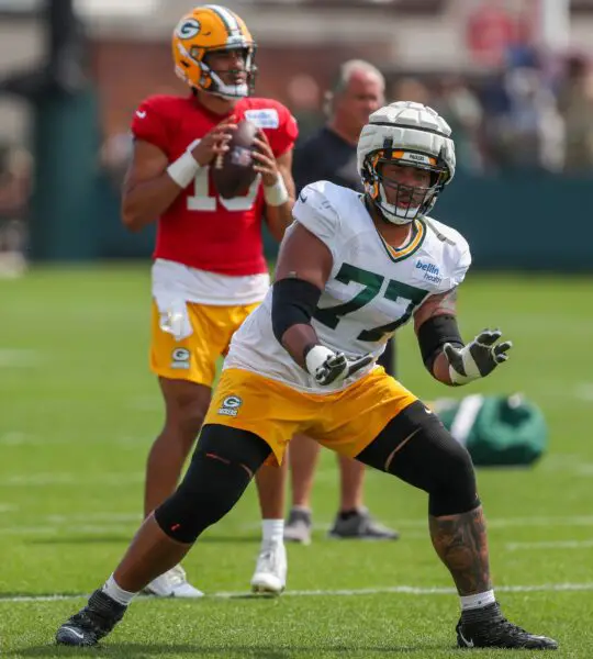 Green Bay Packers offensive lineman Jordan Morgan (77) runs through a drill during the seventh practice of training camp on Tuesday, July 30, 2024, at Ray Nitschke Field in Ashwaubenon, Wis. © Tork Mason/USA TODAY NETWORK-Wisconsin / USA TODAY NETWORK