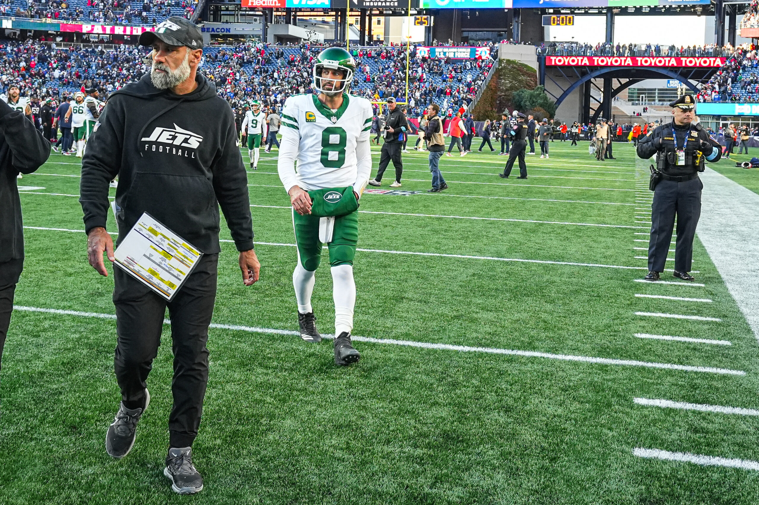 Oct 27, 2024; Foxborough, Massachusetts, USA; New York Jets quarterback Aaron Rodgers (8) and interim head coach Jeff Ulbrich exits the field after being defeated by the New England Patriots at Gillette Stadium. Mandatory Credit: David Butler II-Imagn Images