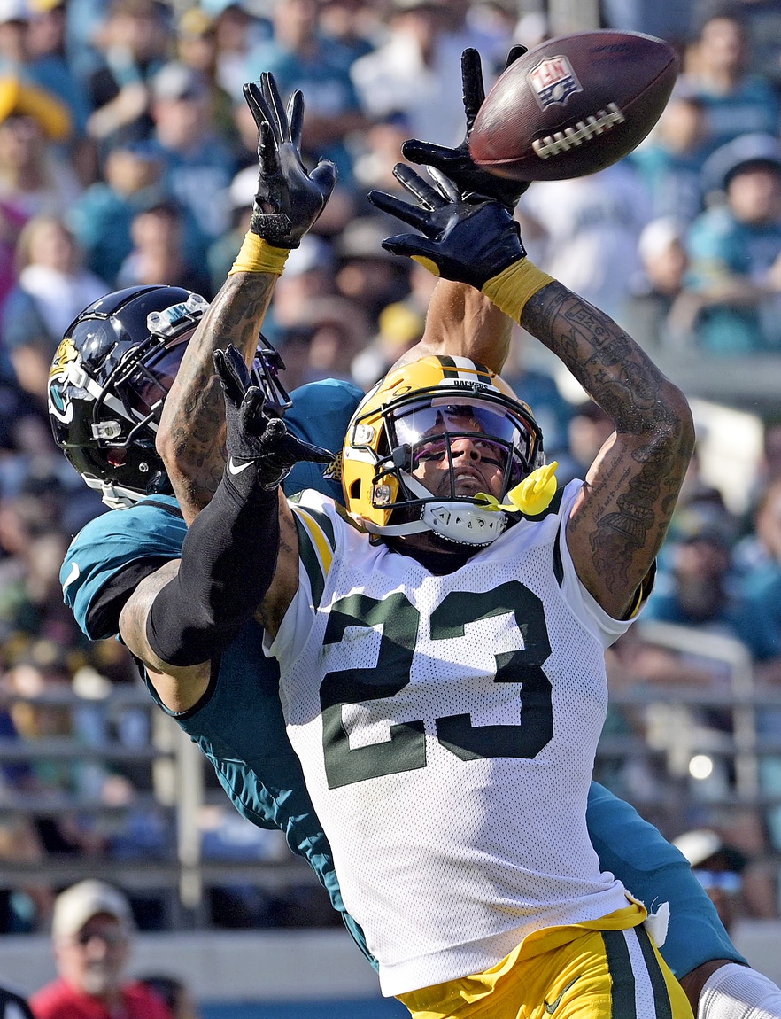 Oct 27, 2024; Jacksonville, Florida, USA; Green Bay Packers defensive back Jaire Alexander (23) defends a pass intended for Jacksonville Jaguars wide receiver Parker Washington (11) during the fourth quarter at EverBank Stadium. Mandatory Credit: Melina Myers-Imagn Images