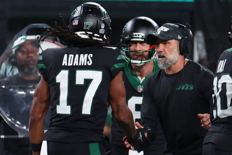 Oct 31, 2024; East Rutherford, New Jersey, USA; New York Jets wide receiver Davante Adams (17), quarterback Aaron Rodgers (8) and interim head coach Jeff Ulbrich celebrate Adams touchdown against the Houston Texans during the second half at MetLife Stadium. Mandatory Credit: Ed Mulholland-Imagn Images