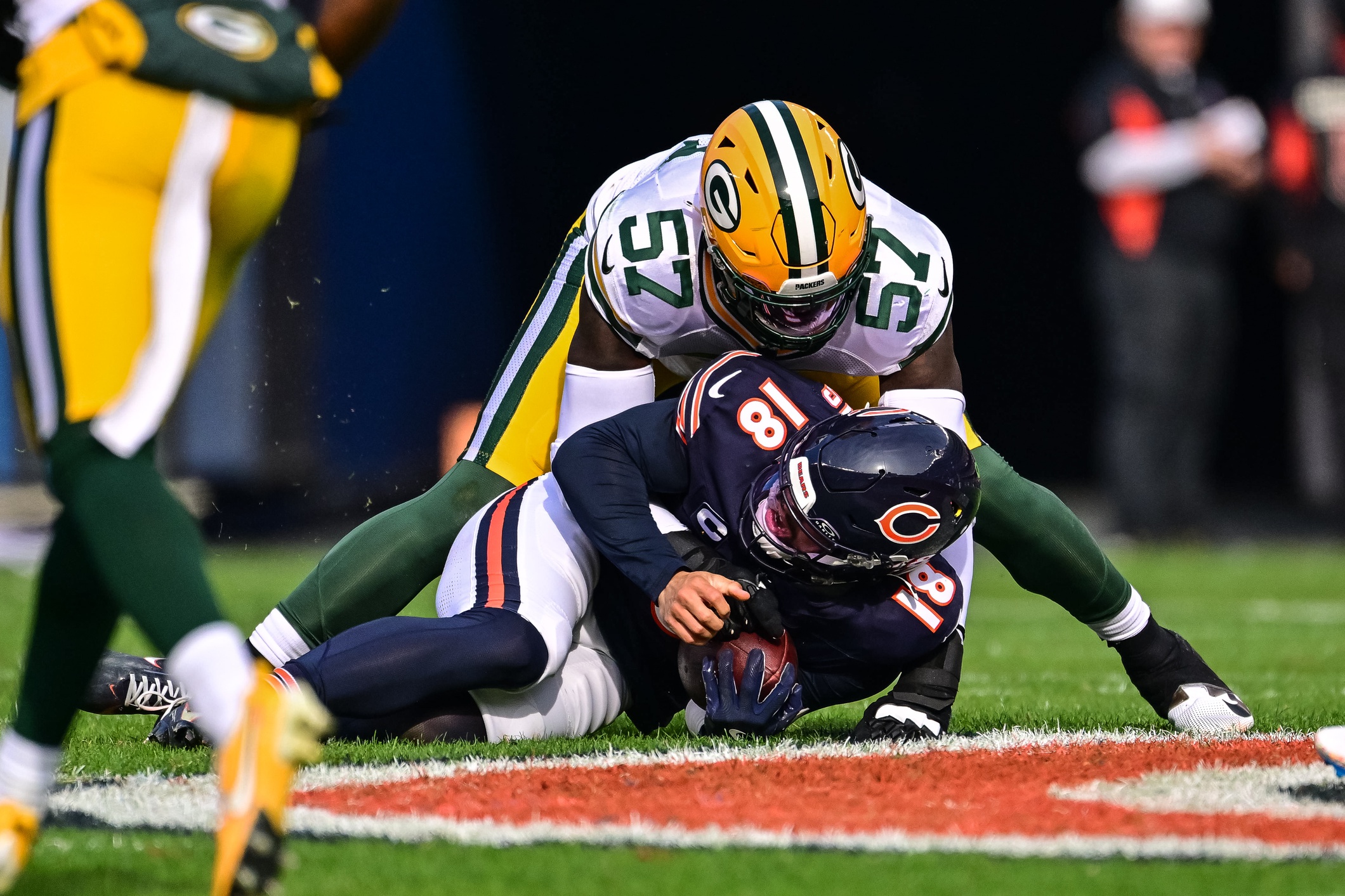 Nov 17, 2024; Chicago, Illinois, USA; Green Bay Packers defensive end Brenton Cox Jr. (57) sacks Chicago Bears quarterback Caleb Williams (18) during the second quarter at Soldier Field. Mandatory Credit: Daniel Bartel-Imagn Images