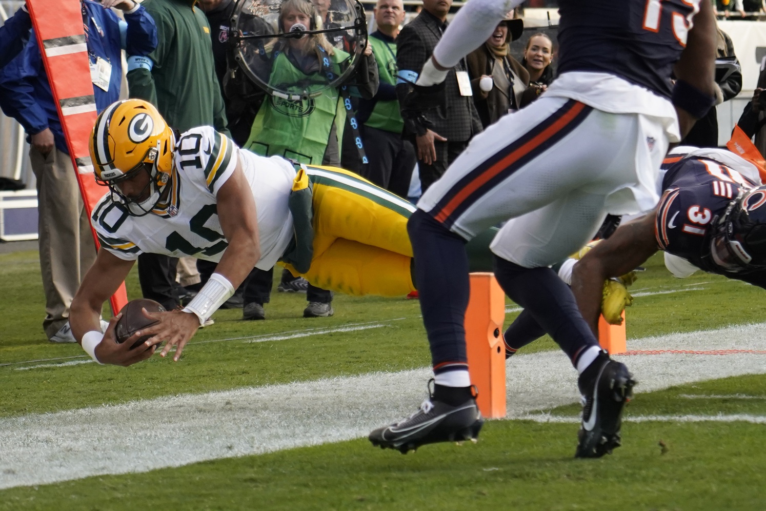 Nov 17, 2024; Chicago, Illinois, USA; Green Bay Packers quarterback Jordan Love (10) dives into the end zone against Chicago Bears safety Kevin Byard III (31) during the second half at Soldier Field. Mandatory Credit: David Banks-Imagn Images