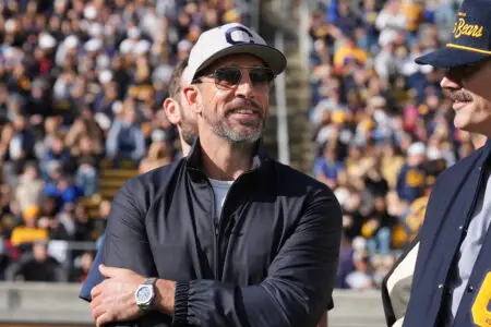 Nov 23, 2024; Berkeley, California, USA; California Golden Bears former quarterback Aaron Rodgers stands on the field before the start of the second quarter against the Stanford Cardinal at California Memorial Stadium. Mandatory Credit: Darren Yamashita-Imagn Images