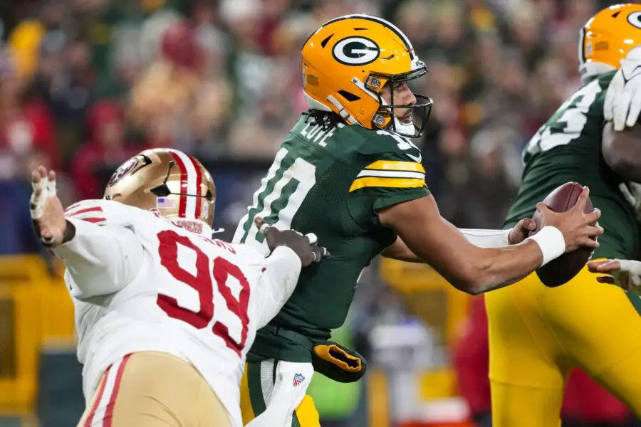 Nov 24, 2024; Green Bay, Wisconsin, USA; Green Bay Packers quarterback Jordan Love (10) steps away from pressure applied by San Francisco 49ers defensive tackle Maliek Collins (99) during the third quarter at Lambeau Field. Mandatory Credit: Jeff Hanisch-Imagn Images