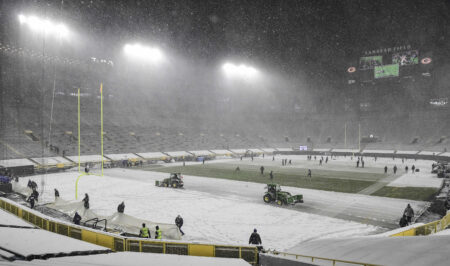 Dec 27, 2020; Green Bay, Wisconsin, USA; The Lambeau Field field crew remove snow before start of game between the Green Bay Packers and Tennessee Titans. Mandatory Credit: Benny Sieu-Imagn Images