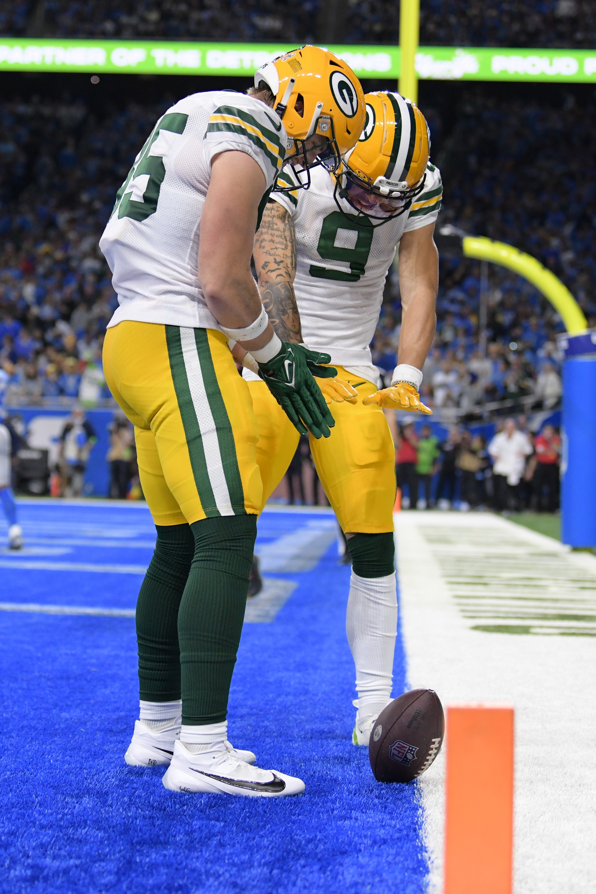 Nov 23, 2023; Detroit, Michigan, USA; Green Bay Packers tight end Tucker Kraft (85) and wide receiver Christian Watson (9) celebrate in the end zone after Kraft caught a touchdown pass from quarterback Jordan Love (10) (not pictured) against the Detroit Lions in the first quarter at Ford Field. Mandatory Credit: Lon Horwedel-Imagn Images