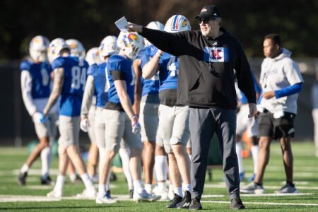 Kansas assistant head coach and offensive coordinator Jeff Grimes directs players