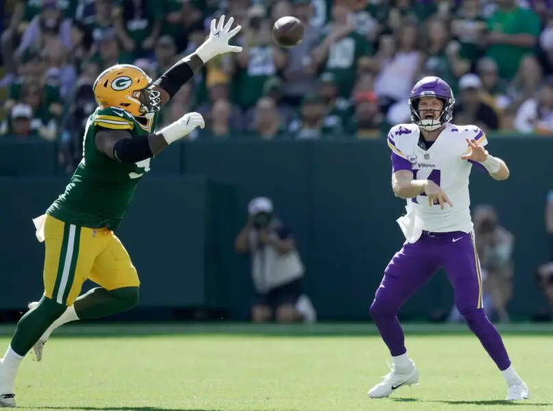 Minnesota Vikings quarterback Sam Darnold (14) is presses by Green Bay Packers defensive tackle Kenny Clark (97) during the first quarter of their game Sunday, September 29, 2024 at Lambeau Field in Green Bay, Wisconsin. © Mark Hoffman/Milwaukee Journal Sentinel / USA TODAY NETWORK via Imagn Images