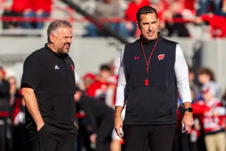 Nov 23, 2024; Lincoln, Nebraska, USA; Nebraska Cornhuskers head coach Matt Rhule and Wisconsin Badgers head coach Luke Fickell talk before a game at Memorial Stadium. Mandatory Credit: Dylan Widger-Imagn Images