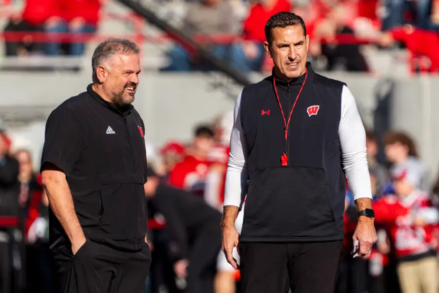 Nov 23, 2024; Lincoln, Nebraska, USA; Nebraska Cornhuskers head coach Matt Rhule and Wisconsin Badgers head coach Luke Fickell talk before a game at Memorial Stadium. Mandatory Credit: Dylan Widger-Imagn Images