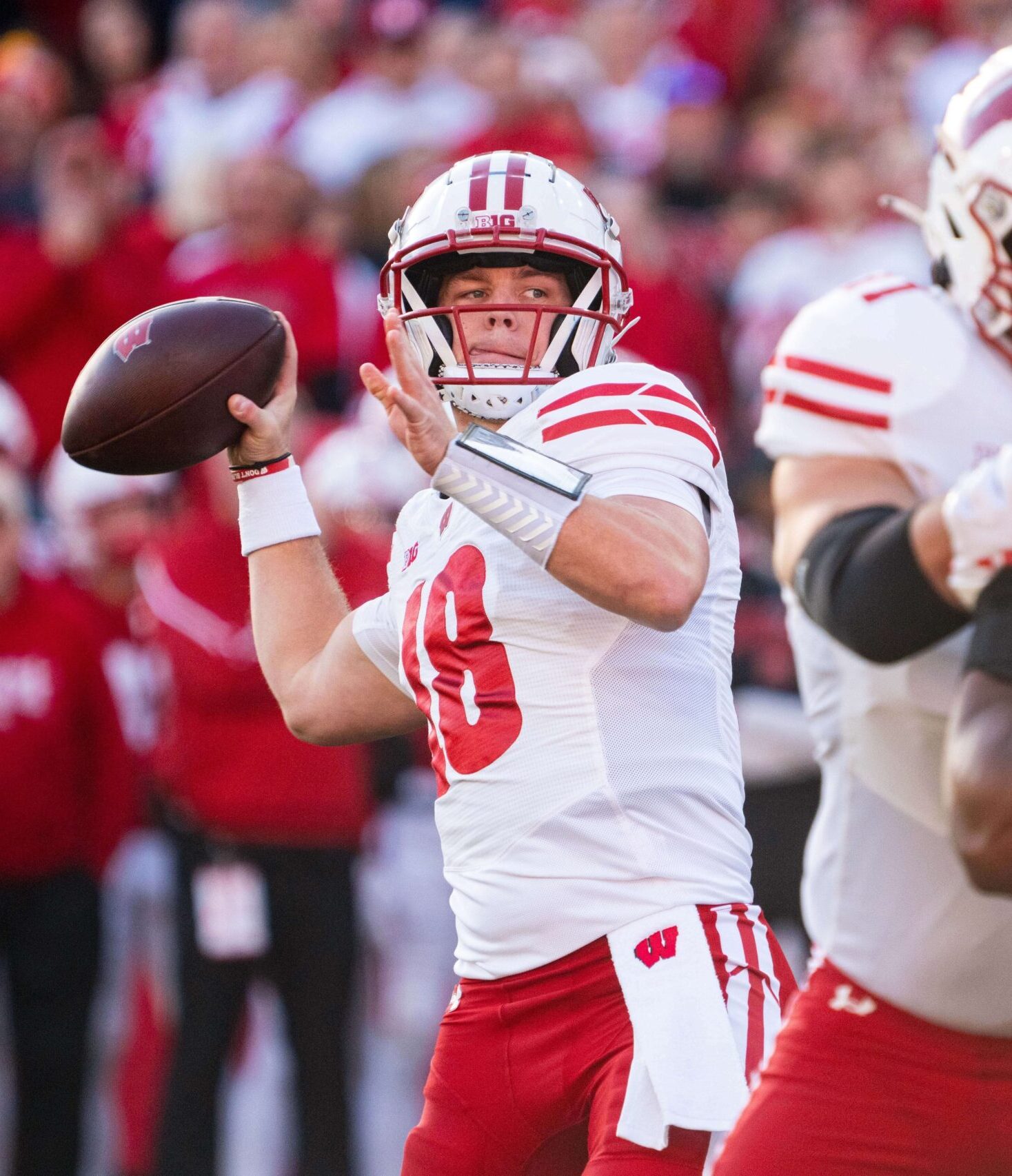 Wisconsin Badgers quarterback Braedyn Locke (18) and Nebraska Cornhuskers linebacker MJ Sherman (48)