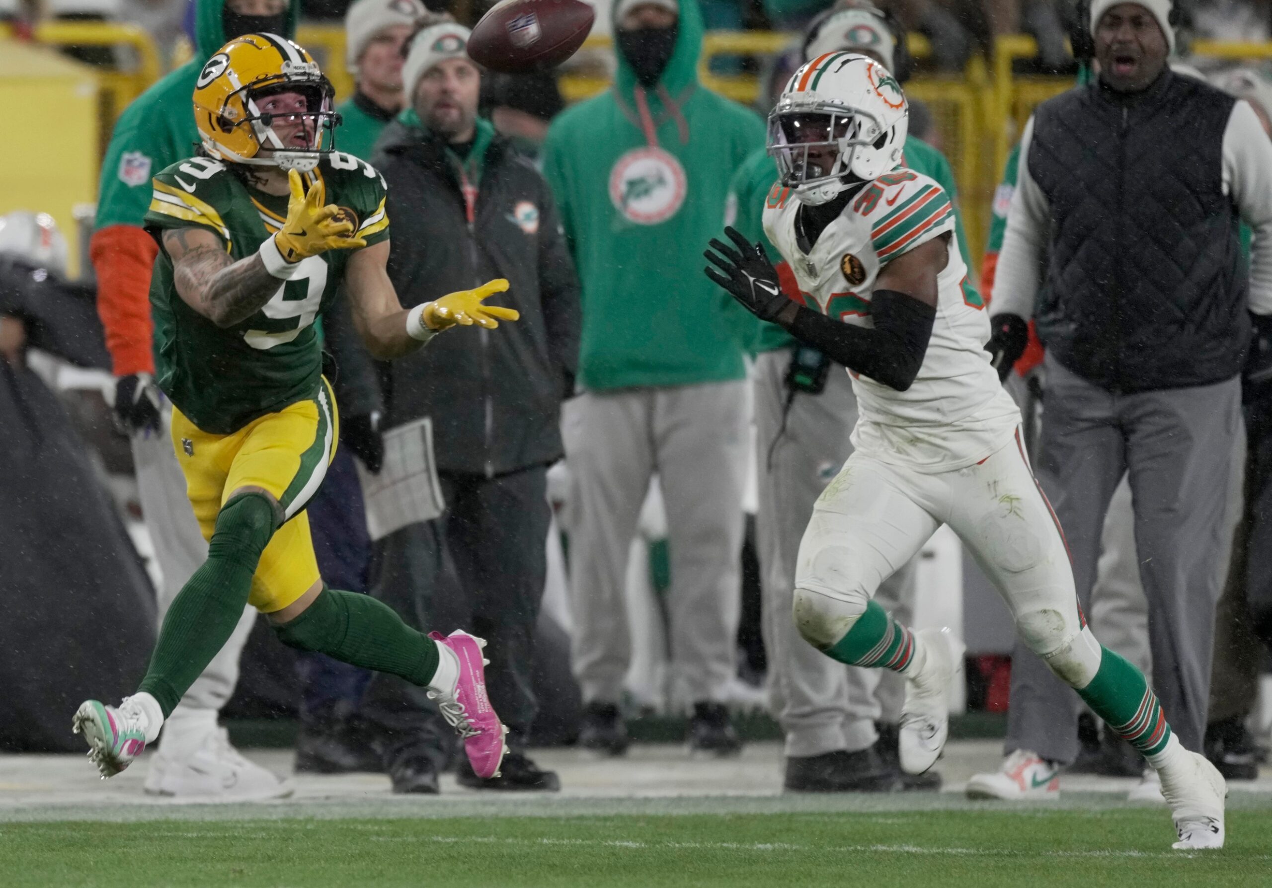 Green Bay Packers' Christian Watson (9) makes a 46-yard reception while being covered by Miami Dolphins cornerback Storm Duck (36) during the third quarter of their game Thursday, November 28, 2024 at Lambeau Field in Green Bay, Wisconsin. © Mark Hoffman/Milwaukee Journal Sentinel / USA TODAY NETWORK via Imagn Images