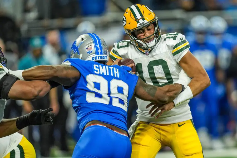 Green Bay Packers quarterback Jordan Love (10) is sacked by Detroit Lions defensive end Za'Darius Smith (99)