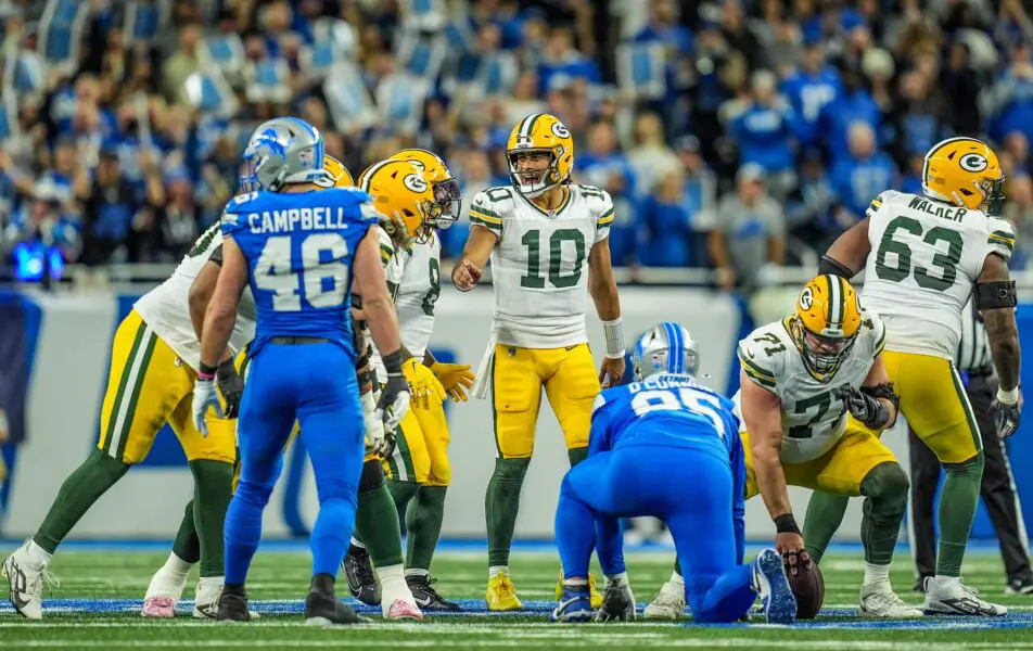 Green Bay Packers quarterback Jordan Love (10) tries to yell out the play over the roar of the crowd at the line