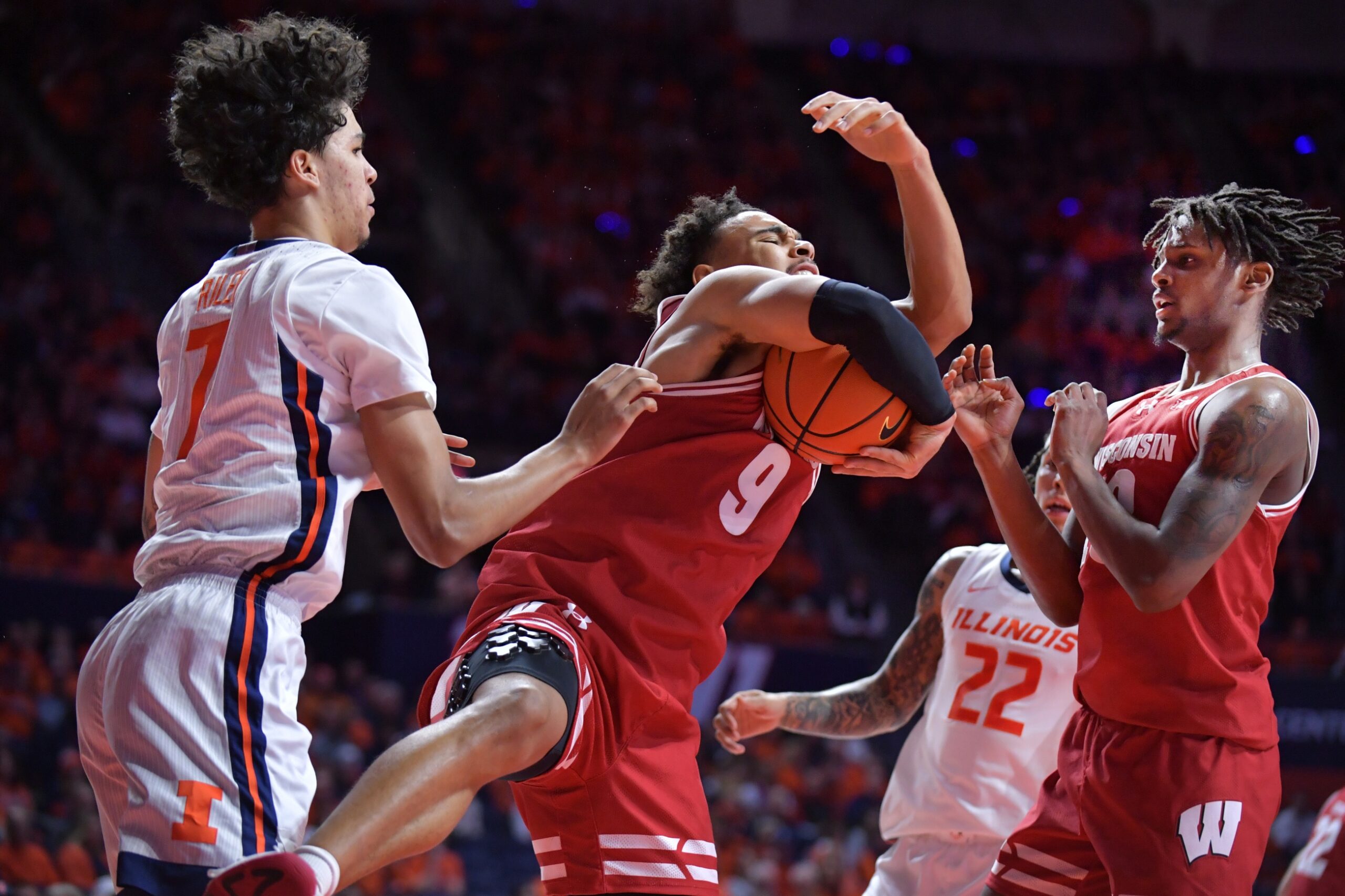 Wisconsin Badgers guard John Tonje (9) pulls down a rebound