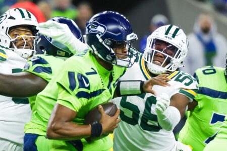 Dec 15, 2024; Seattle, Washington, USA; Green Bay Packers linebacker Edgerrin Cooper (56) sacks Seattle Seahawks quarterback Geno Smith (7) during the first quarter at Lumen Field. Mandatory Credit: Joe Nicholson-Imagn Images