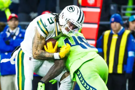 Dec 15, 2024; Seattle, Washington, USA; Seattle Seahawks linebacker Tyrice Knight (48) tackles Green Bay Packers wide receiver Christian Watson (9) following a reception by Watson during the third quarter at Lumen Field. Mandatory Credit: Joe Nicholson-Imagn Images