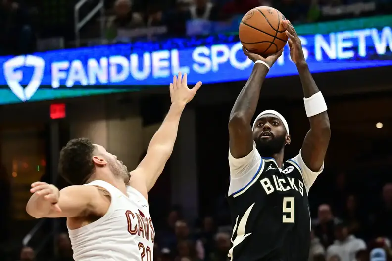 Dec 20, 2024; Cleveland, Ohio, USA; Milwaukee Bucks forward Bobby Portis (9) shoots over the defense of Cleveland Cavaliers forward Georges Niang (20) during the first half at Rocket Mortgage FieldHouse. Mandatory Credit: Ken Blaze-Imagn Images