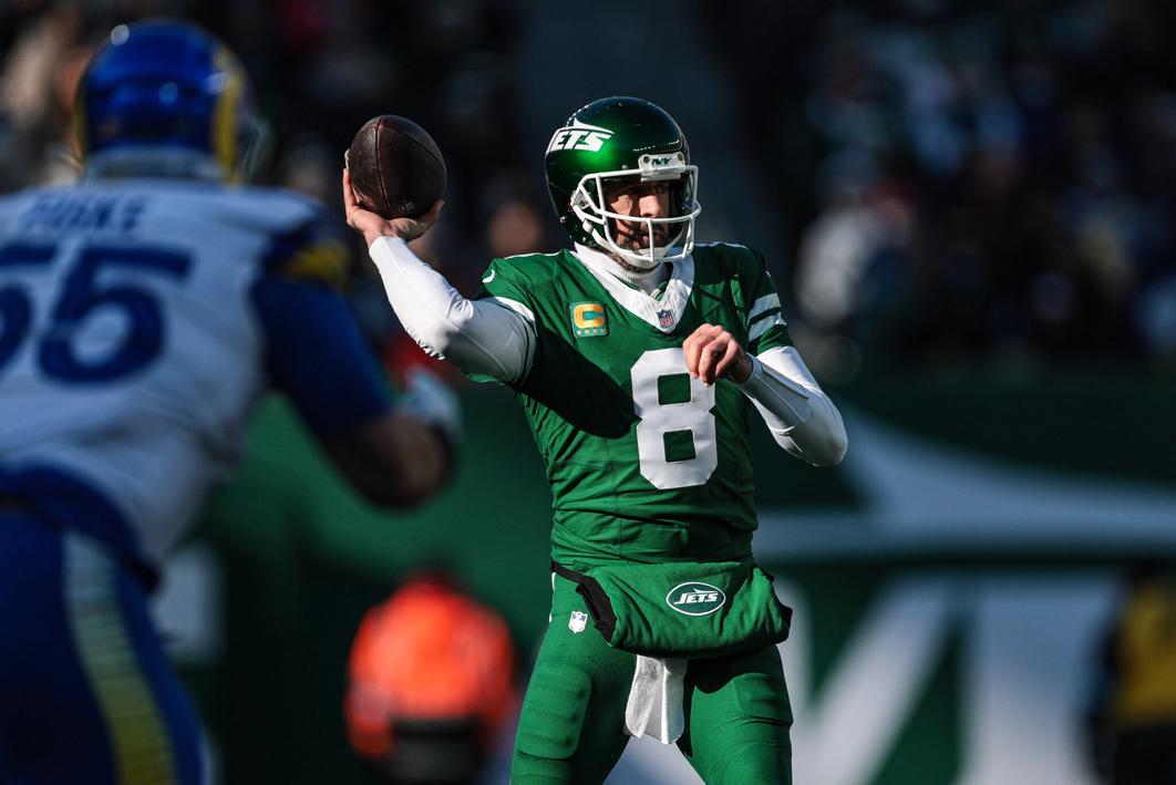 Dec 22, 2024; East Rutherford, New Jersey, USA; New York Jets quarterback Aaron Rodgers (8) throws the ball during the first half against the Los Angeles Rams at MetLife Stadium. Mandatory Credit: Vincent Carchietta-Imagn Images