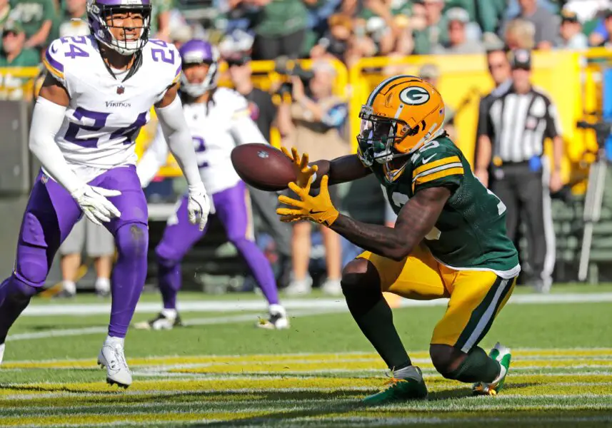 Green Bay Packers wide receiver Dontayvion Wicks (13) scoring a touchdown against Minnesota Vikings safety Camryn Bynum (24)