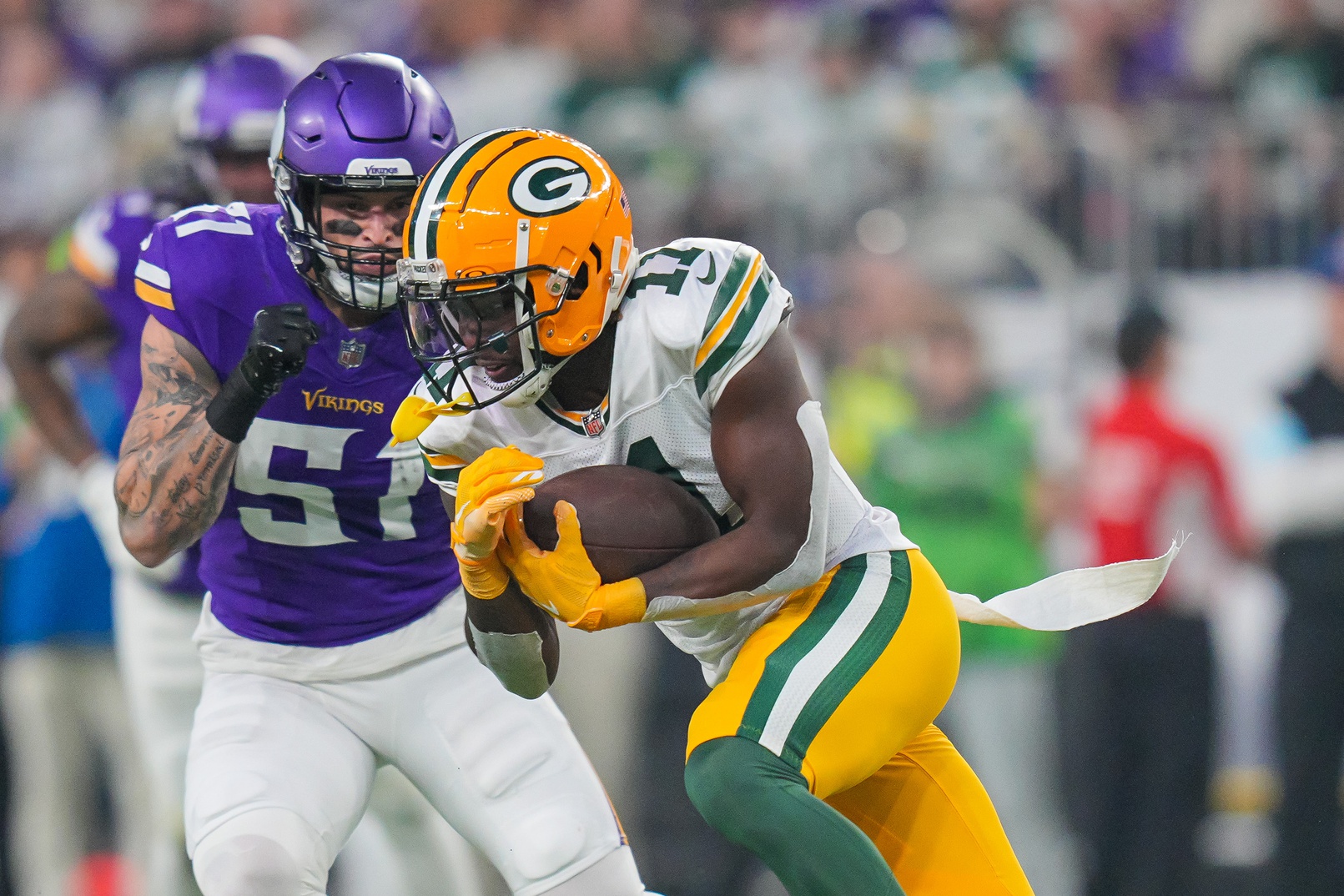 Dec 29, 2024; Minneapolis, Minnesota, USA; Green Bay Packers wide receiver Jayden Reed (11) runs after the catch against Minnesota Vikings linebacker Blake Cashman (51) in the second quarter at U.S. Bank Stadium. Mandatory Credit: Brad Rempel-Imagn Images