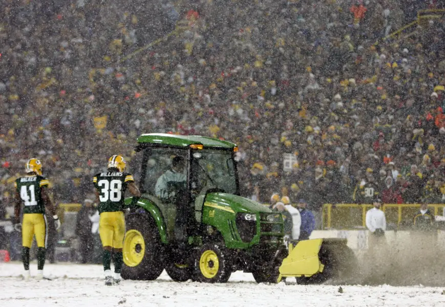 Jan 12, 2008; Green Bay, WI, USA; Green Bay Packers cornerback Frank Walker (41) and cornerback Tramon Williams (38) watch a tractor shovel snow off of the field during the third quarter of the NFC divisional playoff game at Lambeau Field. The Packers beat the Seahawks 42-20. Mandatory Credit: Jerry Lai-Imagn Images