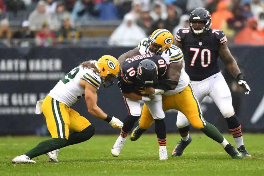 Green Bay Packers defensive tackle Mike Daniels and outside linebacker Clay Matthews tackle Chicago Bears quarterback Mitchell Trubisky.