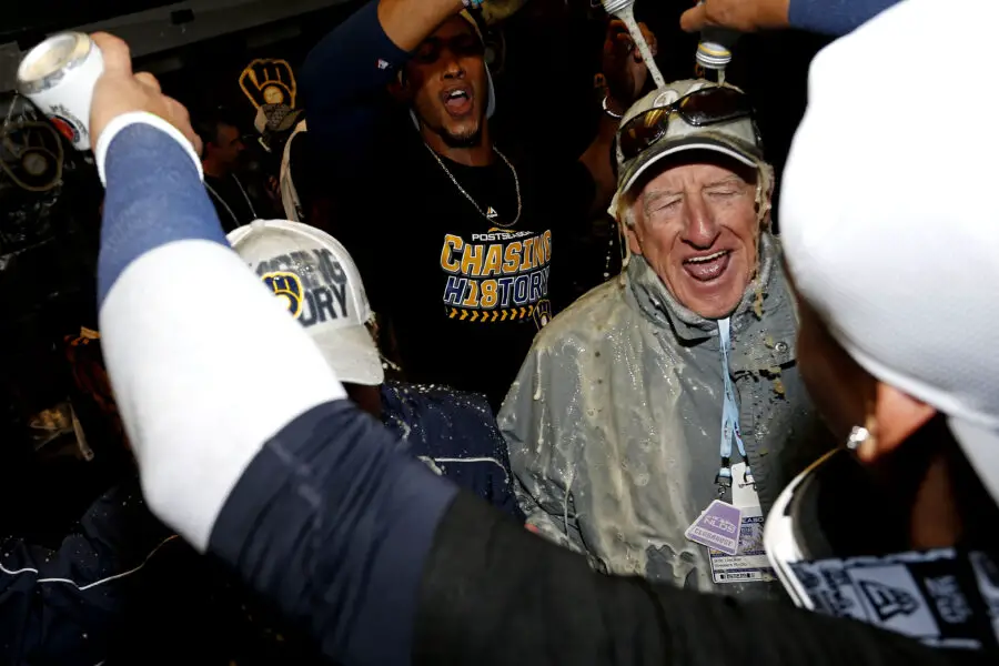 Oct 7, 2018; Denver, CO, USA; The Milwaukee Brewers celebrate with broadcaster Bob Uecker after beating the Colorado Rockies in game three of the 2018 NLDS playoff baseball series at Coors Field. Mandatory Credit: Russell Lansford-Imagn Images