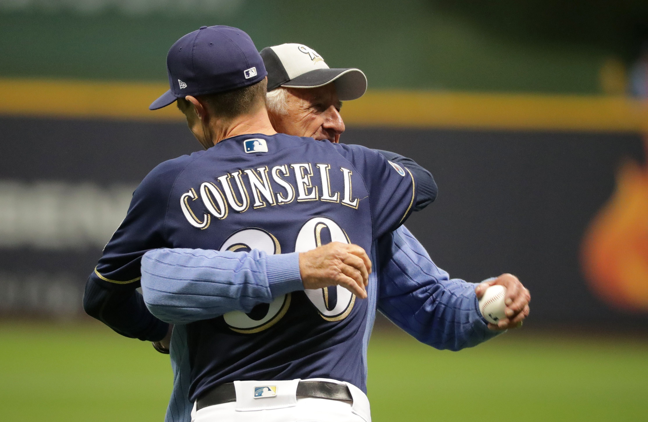 Legendary Brewers radio broadcaster Bob Uecker hugs Milwaukee Brewers manager Craig Counsell (30) after throwing out the first pitch. The Brewers play the Los Angeles Dodgers in Game 1 of the National League Championship Series baseball game Friday, October 12, 2018 at Miller Park in Milwaukee, Wis.  MARK HOFFMAN/MILWAUKEE JOURNAL SENTINEL 