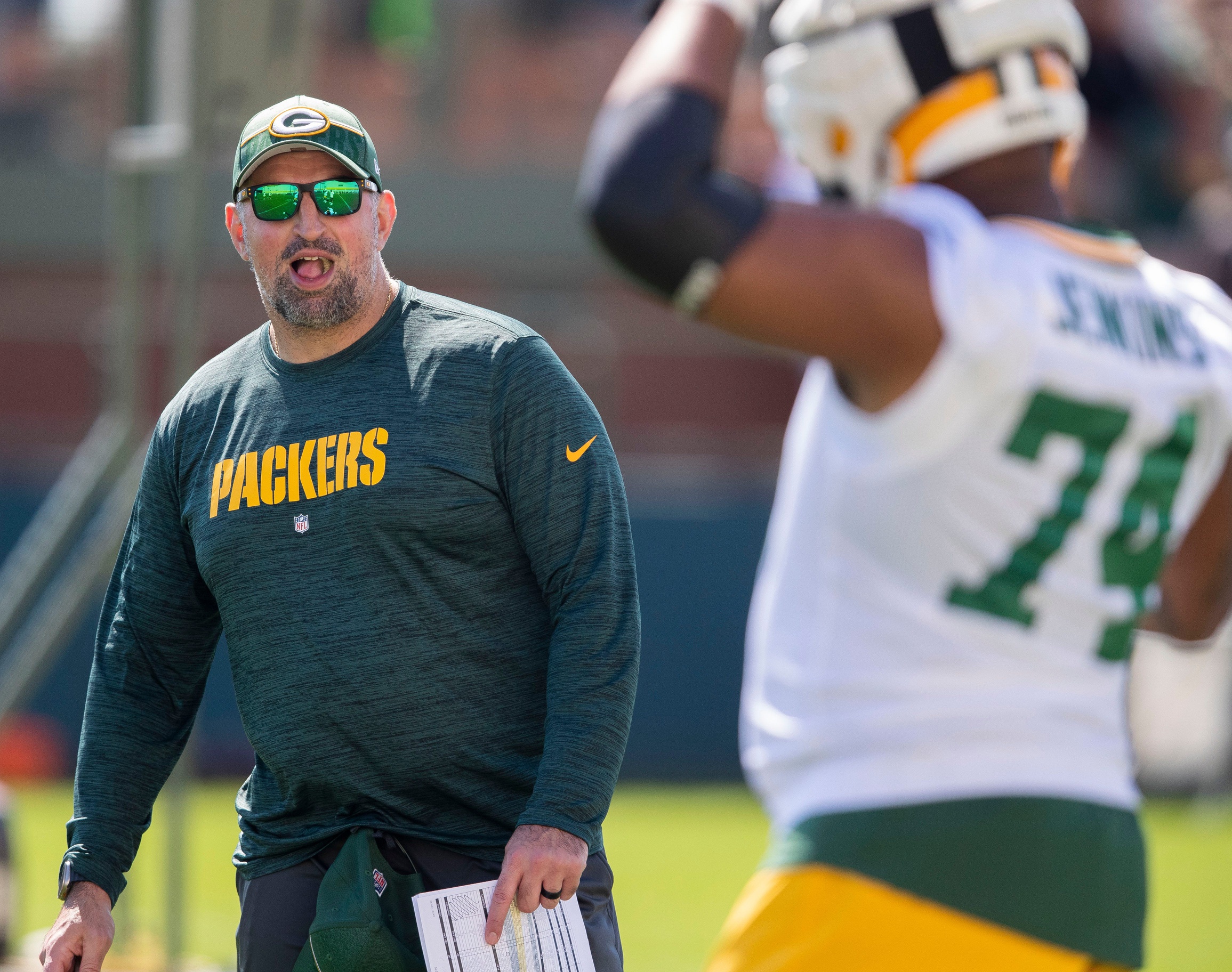 Green Bay Packers offensive coordinator Adam Stenavich gives feedback to guard Elgton Jenkins (74) during practice on Saturday, July 29, 2023, at Ray Nitschke Field in Green Bay, Wis. Tork Mason/USA TODAY NETWORK-Wisconsin